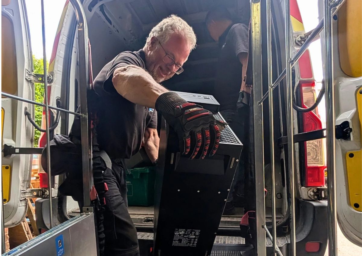 Two Terraguard staff loading network equipment into the collection van